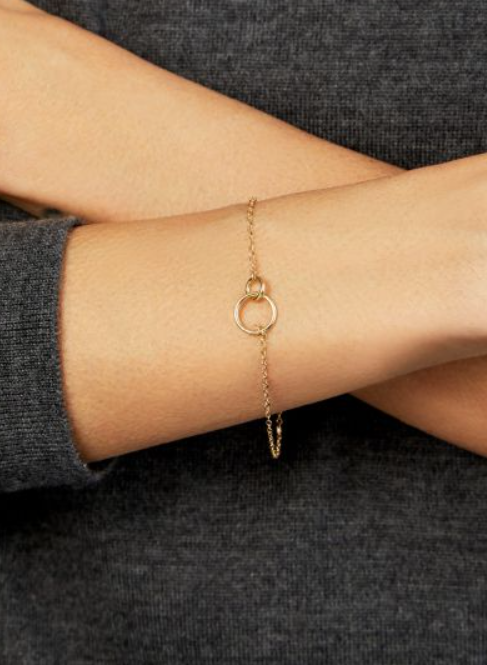 14kt yellow gold interlocking rings on chain bracelet shown on wrist